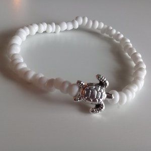White bead with silver turtle ankle bracelet